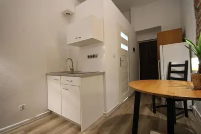 a kitchen and dining room with a table and a sink at Krakow Central Vintage Apartment by Rently in Kraków