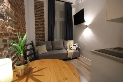 a living room with a couch and a table at Krakow Central Vintage Apartment by Rently in Kraków