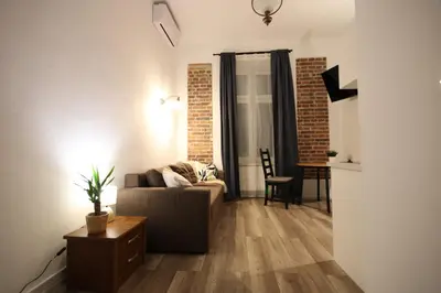 a living room with a couch and a table at Krakow Central Vintage Apartment by Rently in Kraków