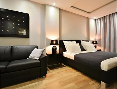 a bedroom with a bed and a couch at Holiday Apartments Browar Lubicz Krakow Stare Miasto in Kraków