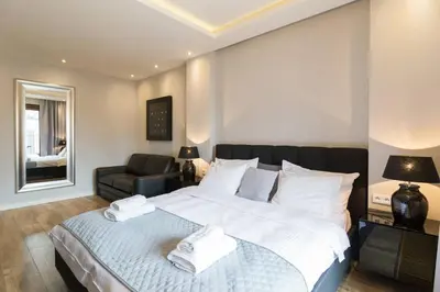 a bedroom with a large bed with towels on it at Holiday Apartments Browar Lubicz Krakow Stare Miasto in Kraków