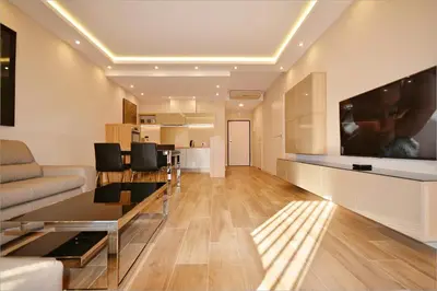 a living room with a couch and a tv on the wall at Holiday Apartments Browar Lubicz Krakow Stare Miasto in Kraków