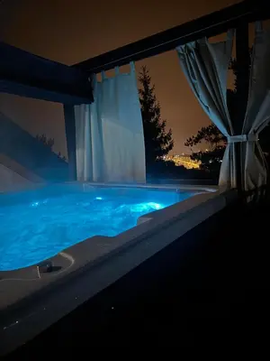 a swimming pool at night with a curtain at Rabczański Taras z jacuzzi in Rabka