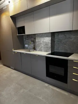 a kitchen with white cabinets and a sink at Rabczański Taras z jacuzzi in Rabka