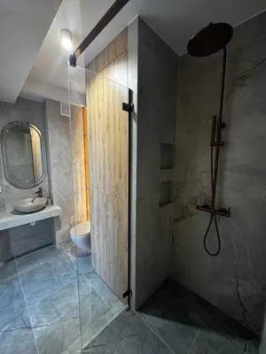 a bathroom with a shower and a sink at Rabczański Taras z jacuzzi in Rabka