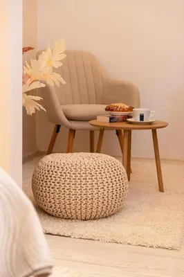 a chair and a coffee table in a room at Kazimierz Residence Apartments Parking - by Staymoovers in Kraków
