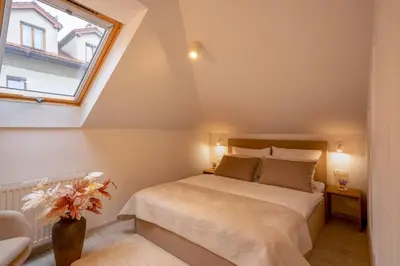 a bedroom with a bed and a window at Kazimierz Residence Apartments Parking - by Staymoovers in Kraków