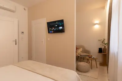 a bedroom with a bed with a tv on the wall at Kazimierz Residence Apartments Parking - by Staymoovers in Kraków