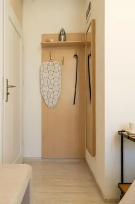 a hallway with a wooden door in a room at Kazimierz Residence Apartments Parking - by Staymoovers in Kraków