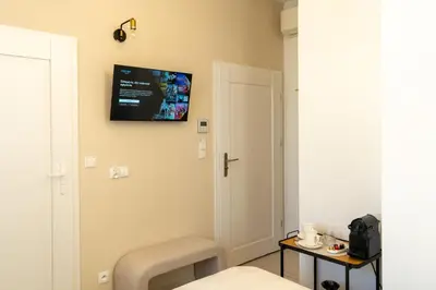 a room with a tv on the wall at Kazimierz Residence Apartments Parking - by Staymoovers in Kraków