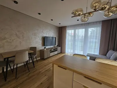 a living room with a dining table and a television at DArt Apartments in Tomice