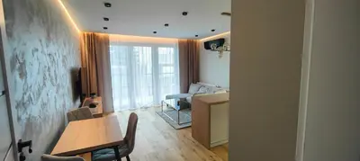 a living room with a table and a dining room at DArt Apartments in Tomice