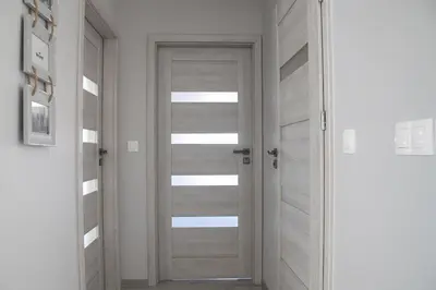 a bedroom with a bed and two night stands with two lamps at Cracow Modern Apartment FREE Parking, Views, Tram in Kraków