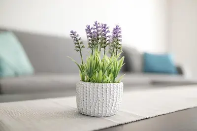 a table with plates and cups and a vase with flowers at Cracow Modern Apartment FREE Parking, Views, Tram in Kraków