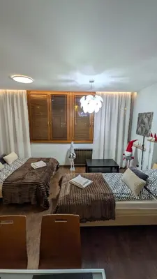 a room with two beds and a table and chairs at KrakowApart Dietla in Kraków