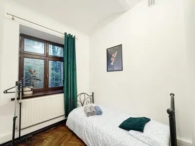 a bedroom with two beds and a window at Batory's Tavern in Kraków