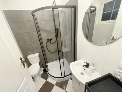 a bathroom with a shower and a toilet and a sink at Batory's Tavern in Kraków