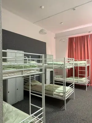 a dorm room with three bunk beds in it at Lanzo 48 in Kraków