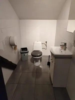 a bathroom with two sinks and two toilets at Lanzo 48 in Kraków