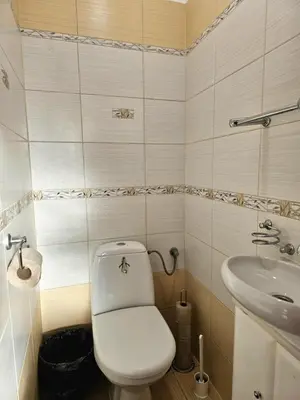 a small bathroom with a toilet and a sink at W1 PRIVATE rooms in Kraków