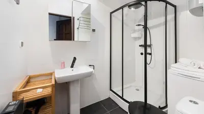 a bathroom with a sink and a shower at Sunshine Loft Cracow, Sun & Snow in Kraków