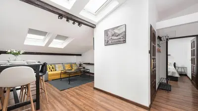 a living room with a table and a dining room at Sunshine Loft Cracow, Sun & Snow in Kraków