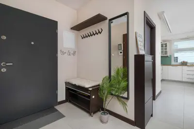 a bathroom with a mirror and a plant in it at Family Apartment in Cracow with Parking, Desk and Bathtub by Noclegi Renters in Kraków