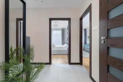 a hallway with a door leading to a bedroom at Family Apartment in Cracow with Parking, Desk and Bathtub by Noclegi Renters in Kraków