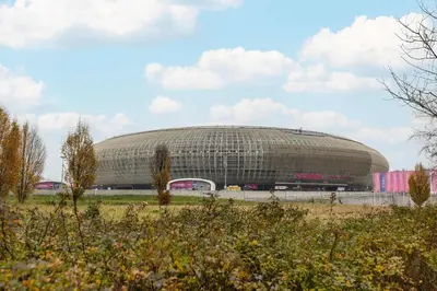 a large building in the middle of a field at Family Apartment in Cracow with Parking, Desk and Bathtub by Noclegi Renters in Kraków