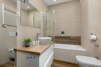 a bathroom with a sink and a tub and a toilet at Family Apartment in Cracow with Parking, Desk and Bathtub by Noclegi Renters in Kraków