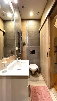 a bathroom with a white sink and a toilet at Św Sebastiana 20 in Kraków