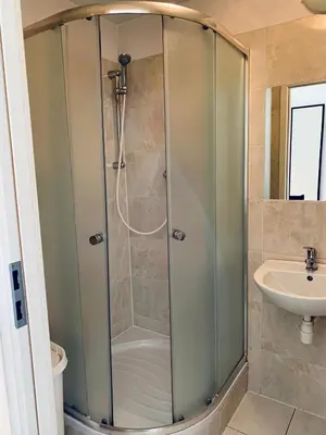a shower stall in a bathroom with a sink at Św Sebastiana 20 in Kraków
