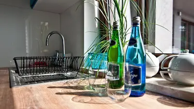 two bottles of wine sitting on a table with glasses at Apartament Mateo in Kraków