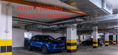 a parking garage with cars parked in it at Apartament Mateo in Kraków