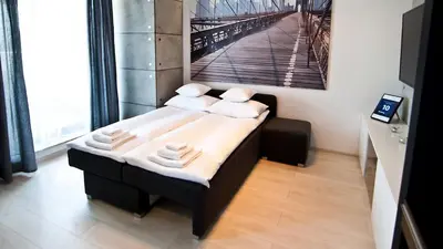 a room with a bed with towels on it at Apartament Mateo in Kraków