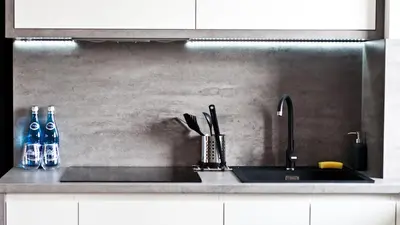 a kitchen counter with a sink and a sink at Apartament Mateo in Kraków