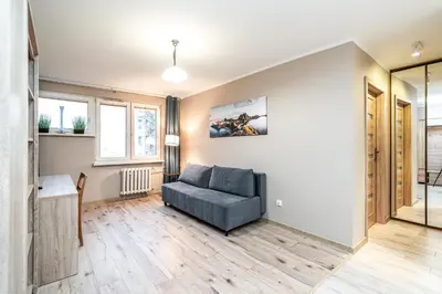 a living room with a couch and a table at RentPlanet - Apartament Olsza in Kraków