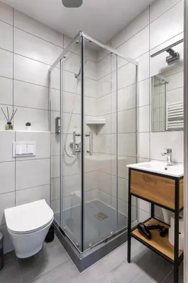a bathroom with a shower and a toilet and a sink at SERENITY New Apartments Kraków in Kraków