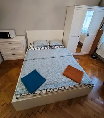 a bedroom with a bed with blue pillows at Daniel Apart Hotel Krakow in Kraków