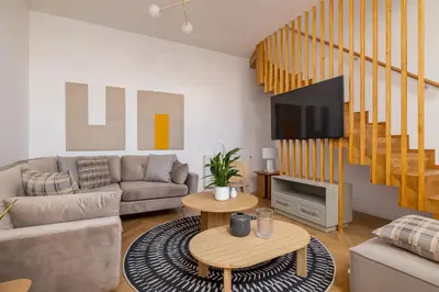 a living room with a couch and a tv at 5 Bedroom apartment - Terrace, Jacuzzi, Sauna in Kraków