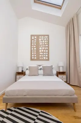 a bedroom with a large bed and a window at 5 Bedroom apartment - Terrace, Jacuzzi, Sauna in Kraków