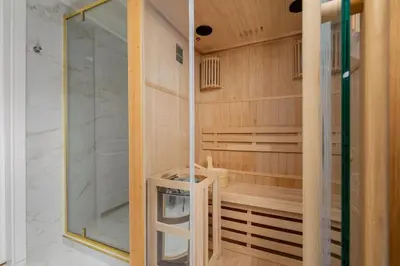 a shower with a glass door in a bathroom at 5 Bedroom apartment - Terrace, Jacuzzi, Sauna in Kraków