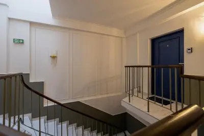 a staircase in a building with a blue door at 5 Bedroom apartment - Terrace, Jacuzzi, Sauna in Kraków