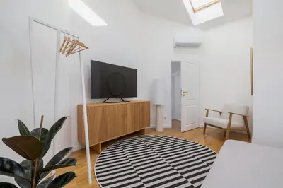 a living room with a television on a wooden cabinet at 5 Bedroom apartment - Terrace, Jacuzzi, Sauna in Kraków