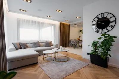 a living room with a couch and a table at Zamkowy Zakątek - Luksusowe domki z jacuzzi in Nowy Wiśnicz