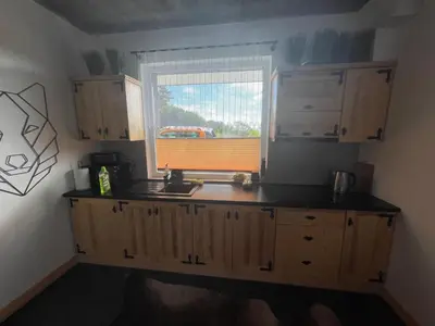 a kitchen with a sink and a window at Domki przy szlaku Szczebel in Lubień