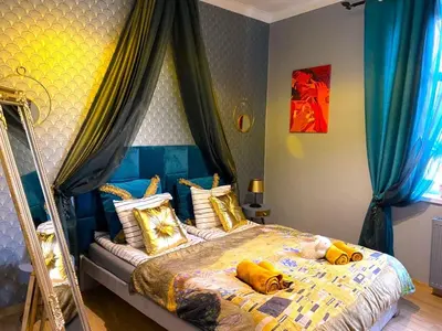 a bedroom with a bed with yellow pillows on it at Gold ROOM in Kraków