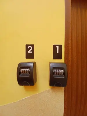 a wall with two clocks on a yellow wall at Gold ROOM in Kraków