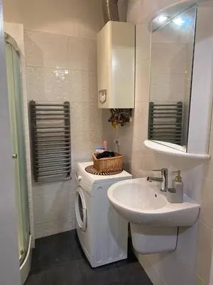a bathroom with a washing machine and a sink at Gold ROOM in Kraków