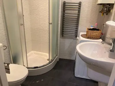 a bathroom with a shower and a toilet and a sink at Gold ROOM in Kraków